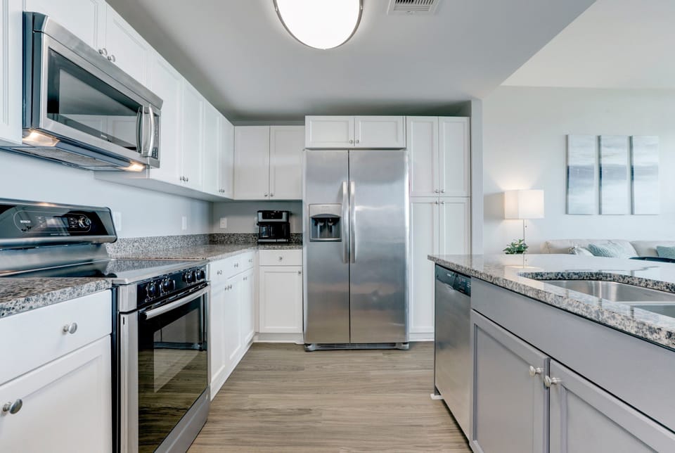 Fully equipped kitchen featuring stainless steel appliances, granite countertops, and ample cabinet space—ideal for cooking and entertaining.