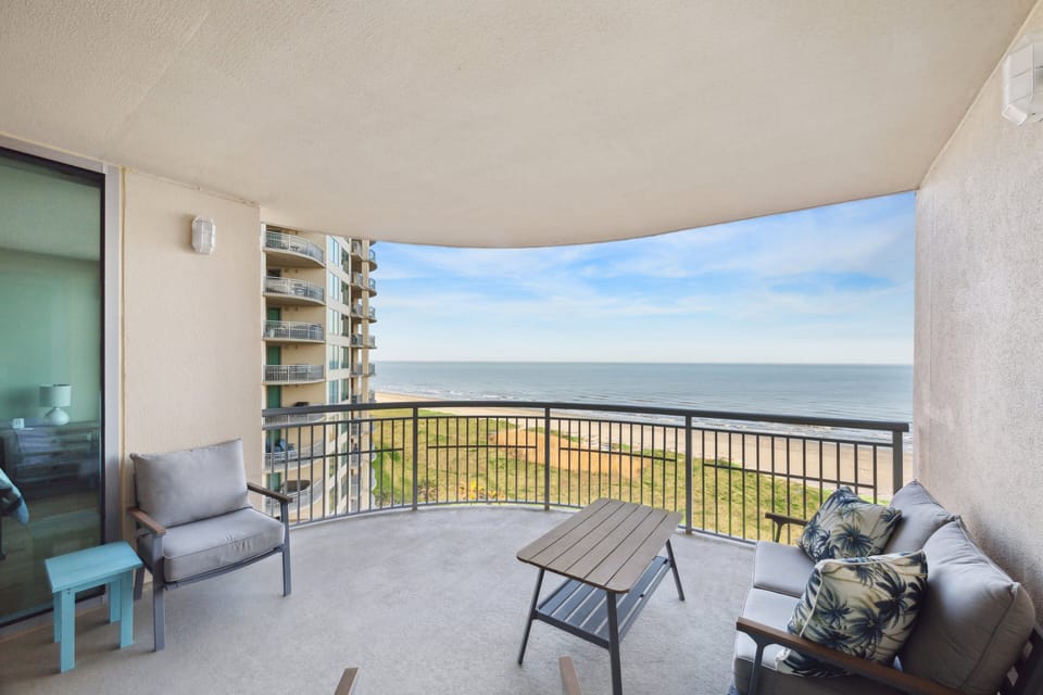 Private beachfront balcony with seating and panoramic views of the Gulf from Palisade Palms.