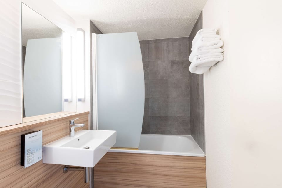 Bathtub, eco-friendly toiletries, hair dryer, towels