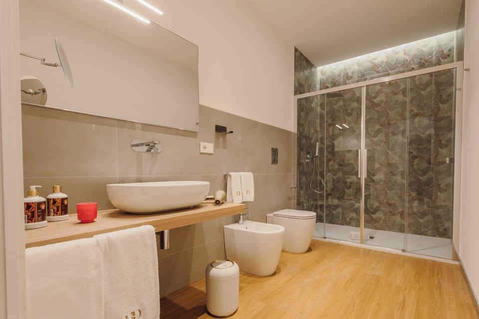 Deluxe Triple Room, City View | Bathroom | Shower, rainfall showerhead, hair dryer, slippers