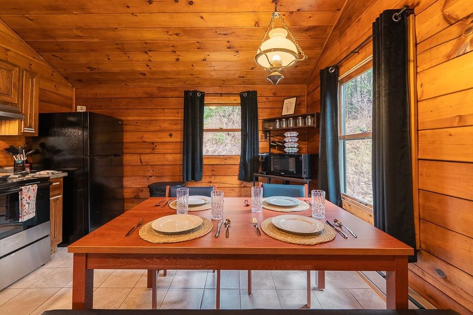 Gather for meals or game night in the cozy dining nook, with seating for four and views of the surrounding forest.