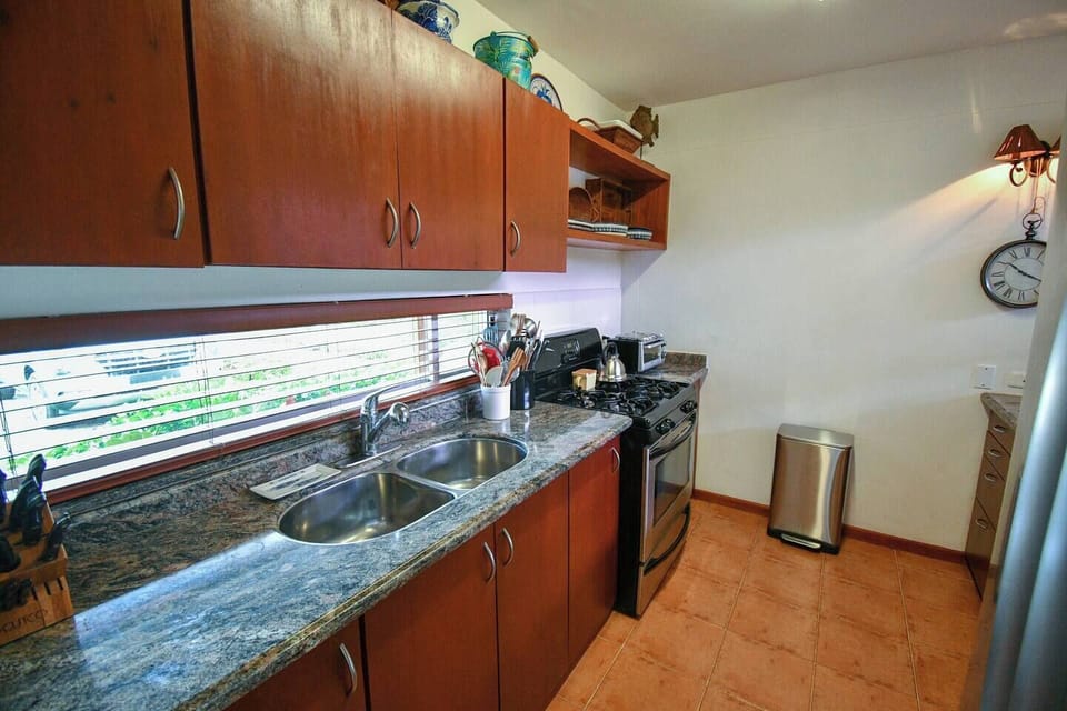 Another view of the kitchen.  Where the trash can is located we have recently added a door way that will also you to enter the kitchen directly from the foyer.  Note the parking right in front of the house through the back splash window.