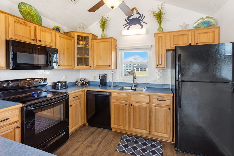 The reverse floor plan on the Top Level features an open-concept Living Area, Dining Area, and a fully equipped Kitchen, making it easy to gather, cook, and share meals with your loved ones.