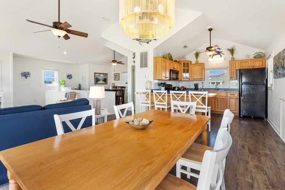 The reverse floor plan on the Top Level features an open-concept Living Area, Dining Area, and a fully equipped Kitchen, making it easy to gather, cook, and share meals with your loved ones.