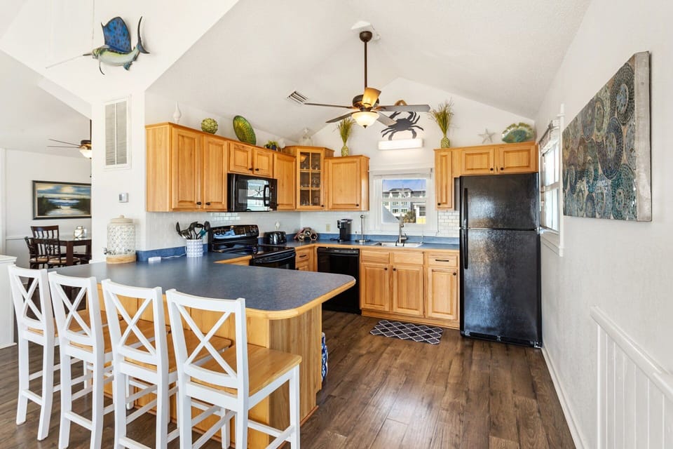 The reverse floor plan on the Top Level features an open-concept Living Area, Dining Area, and a fully equipped Kitchen, making it easy to gather, cook, and share meals with your loved ones.