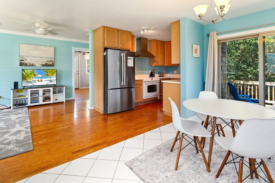 The open-concept Living Area on the Main Level features a flat-screen TV, making it a great space to unwind after a day of sun and surf! And With The adjacent Dining Area with seating for four provides the perfect spot to enjoy a home-cooked meal.