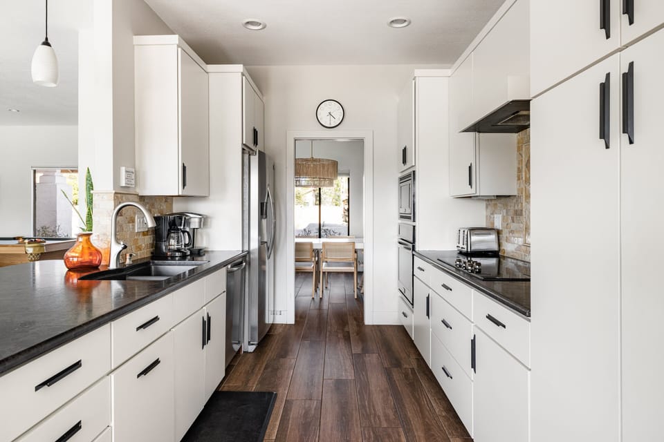 Galley kitchen with stainless steel appliances.