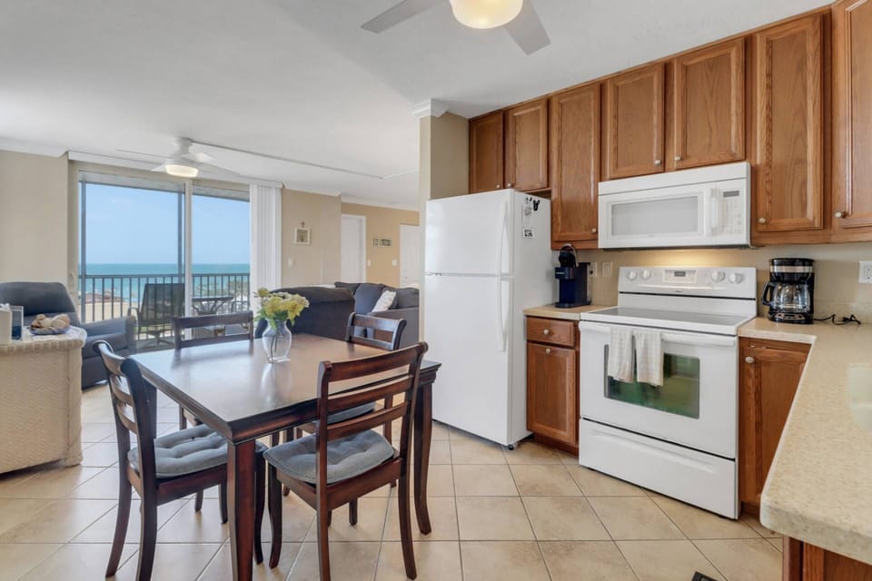 A dining table with seating for four is in the eat-in kitchen.