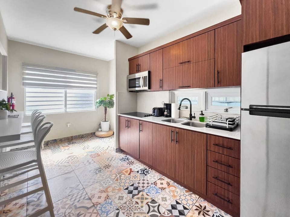 Step into a clean modern kitchen where spacious counters and thoughtful essentials make meal prep effortless