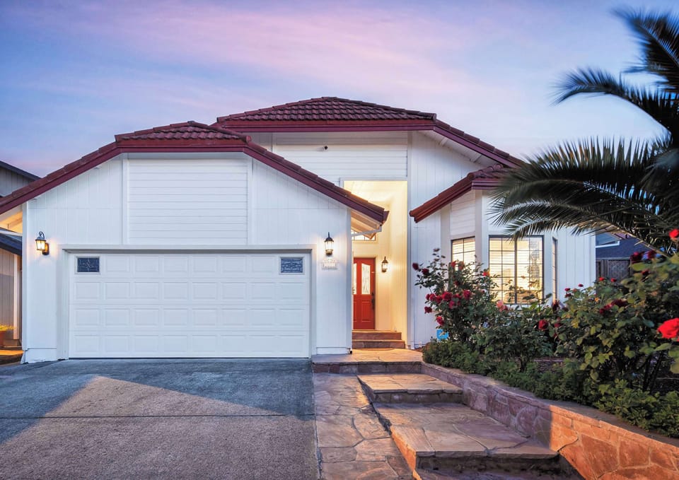 Experience curb appeal at its finest! Our picturesque white house with Italian roofing tiles and exquisite flagstone front decor offers a warm welcome and sets the stage for a memorable stay.