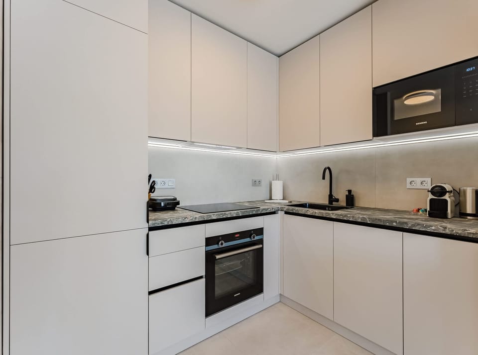 Fully Equipped Custom Kitchen with High-End Appliances, Nespresso Machine & Integrated Cabinetry for Seamless Design

