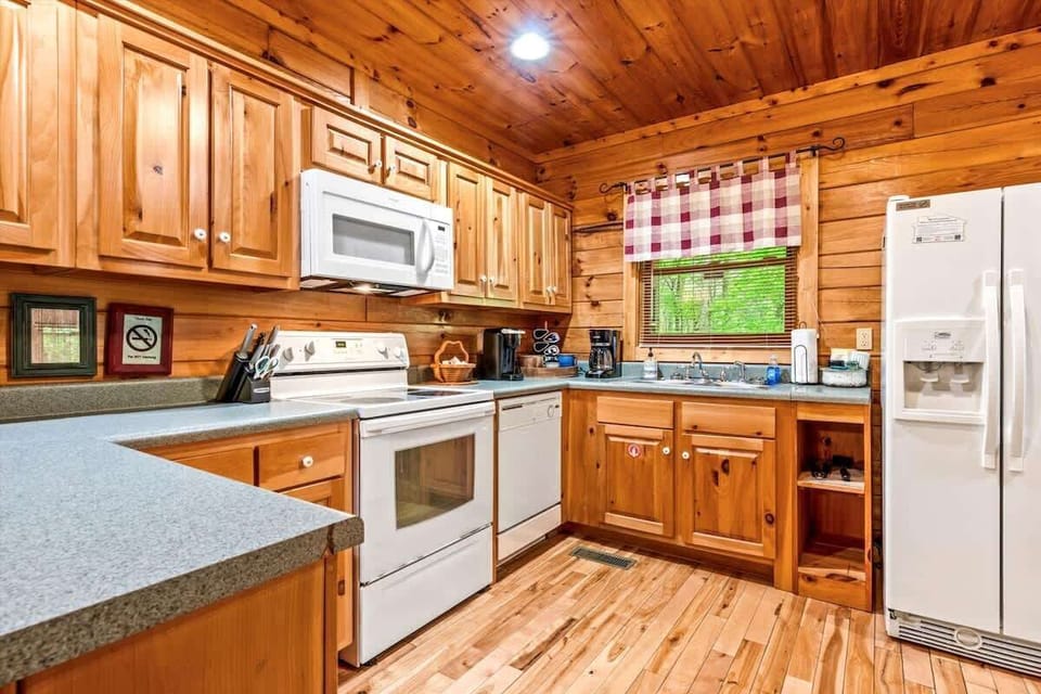 Everything you need is at your fingertips in this well-appointed kitchen, featuring ample counter space, modern appliances, and charming country details that make cooking a pleasure.