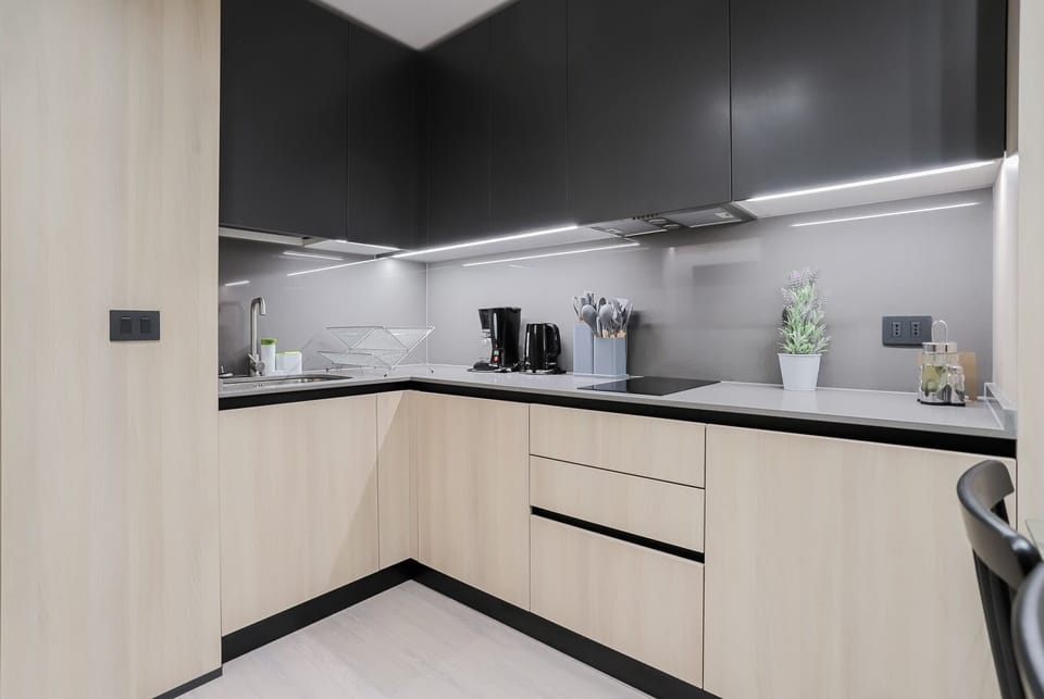 Sleek and modern kitchen with all essentials, perfect for cooking up a storm or enjoying a morning coffee.