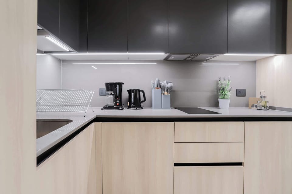 Sleek and modern kitchen with all essentials for a comfortable stay, featuring stylish lighting and contemporary design.