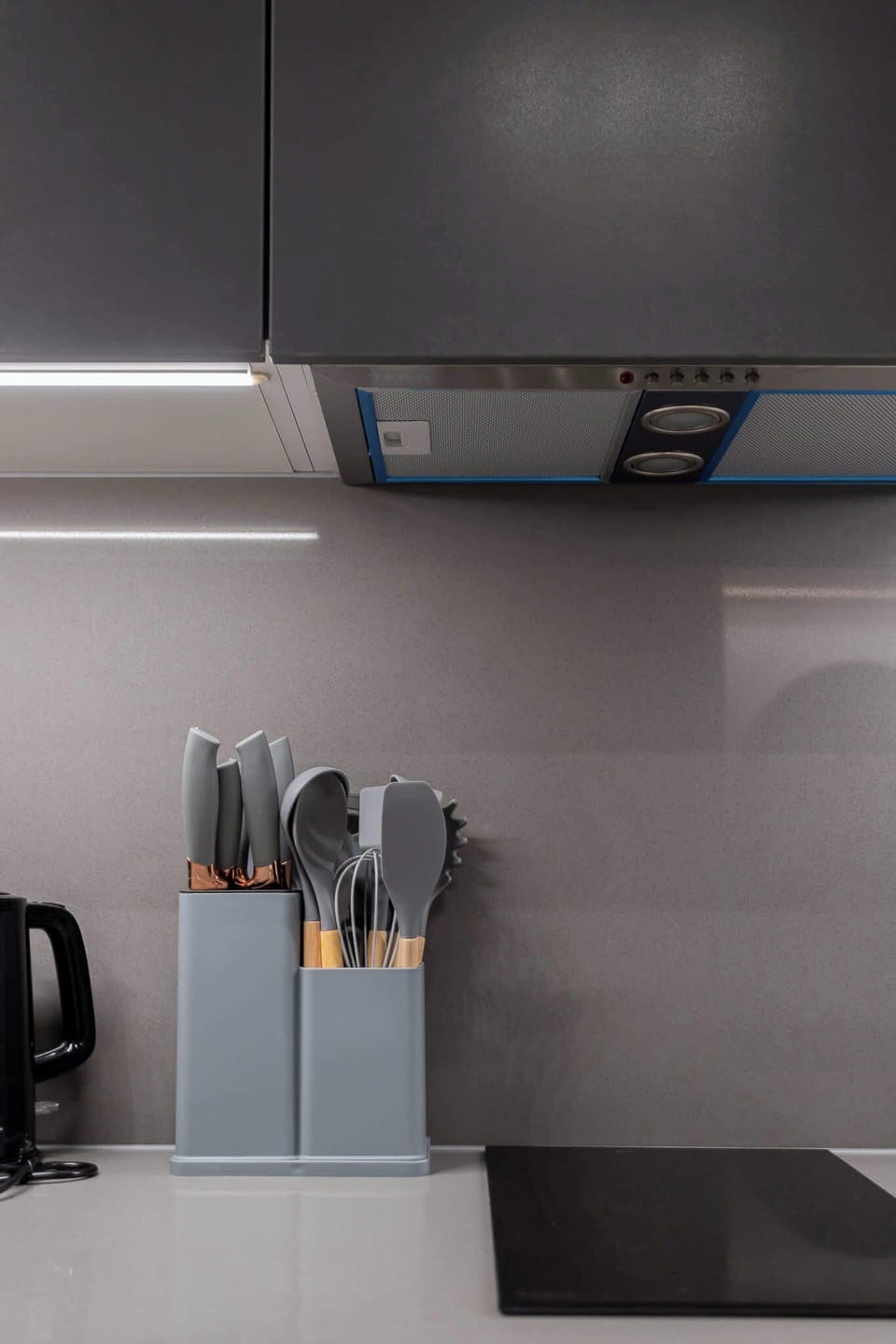 Modern kitchen with sleek design and essential utensils, perfect for preparing meals during your stay.