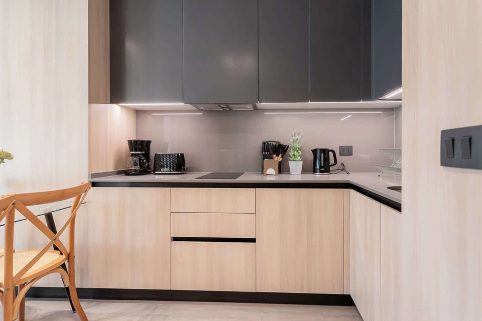 Experience modern living in this sleek kitchen, equipped with top-notch appliances and stylish decor for a perfect stay.