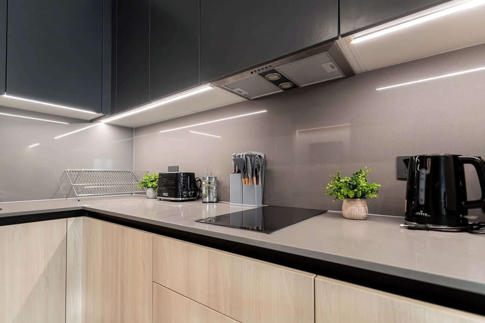 Experience culinary bliss in this modern kitchen, featuring sleek cabinetry and high-end appliances for your cooking adventures.