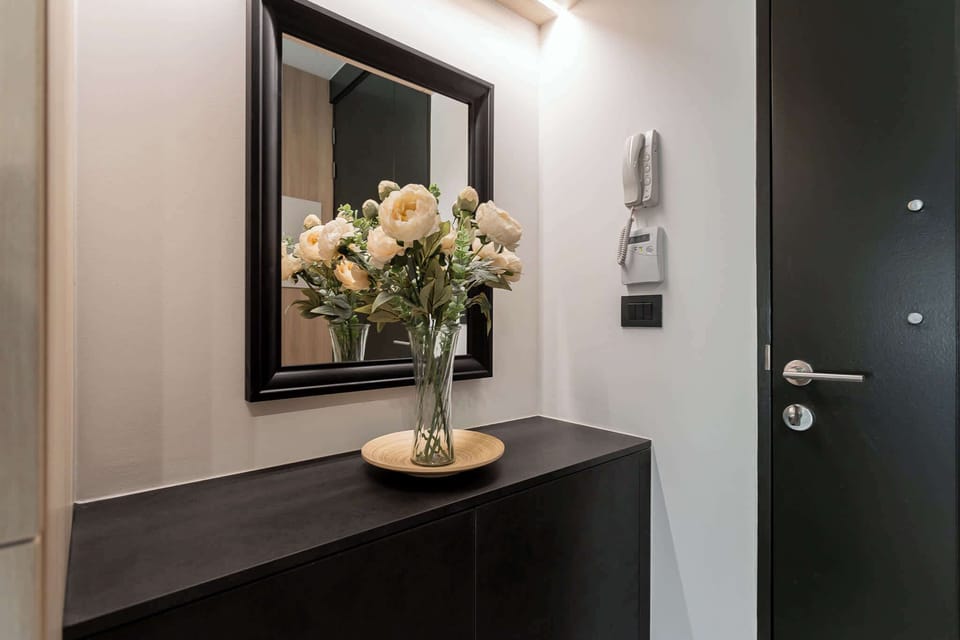 Step into a stylish entryway adorned with fresh flowers, setting a warm and inviting tone for your stay.