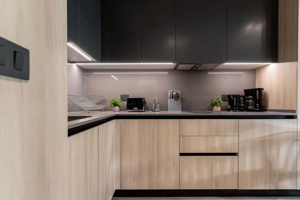 Experience a modern kitchen with sleek cabinetry and essential appliances, perfect for preparing meals during your stay.