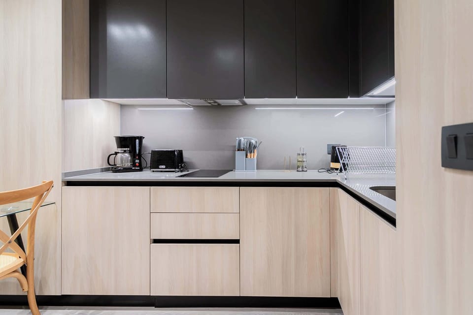 Sleek and modern kitchen with all essentials, perfect for preparing meals and enjoying a cozy dining experience.