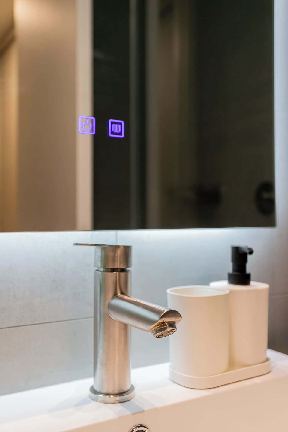 Experience modern luxury with our sleek bathroom featuring a touch-controlled mirror and stylish fixtures.