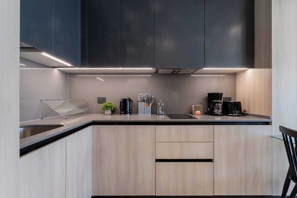 Experience culinary bliss in this modern kitchen, featuring sleek cabinetry and high-end appliances for your cooking adventures.