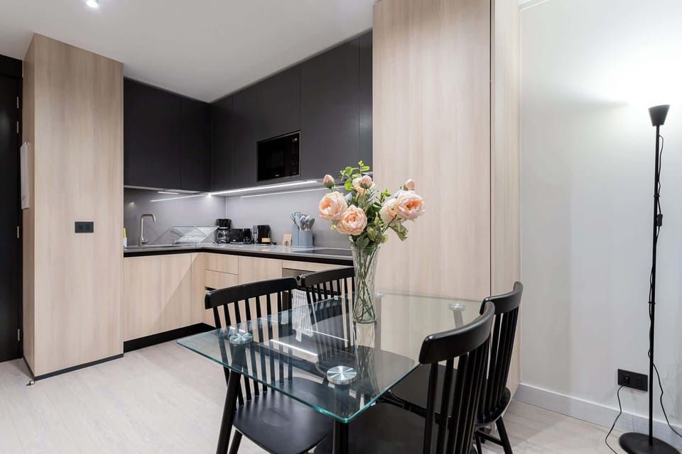 Sleek and modern kitchen with elegant dining space, perfect for enjoying meals and creating culinary delights.