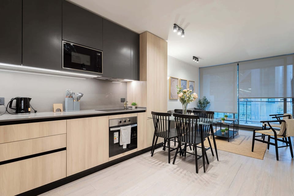 Experience modern elegance in this sleek kitchen and dining area, perfect for culinary adventures and cozy gatherings.