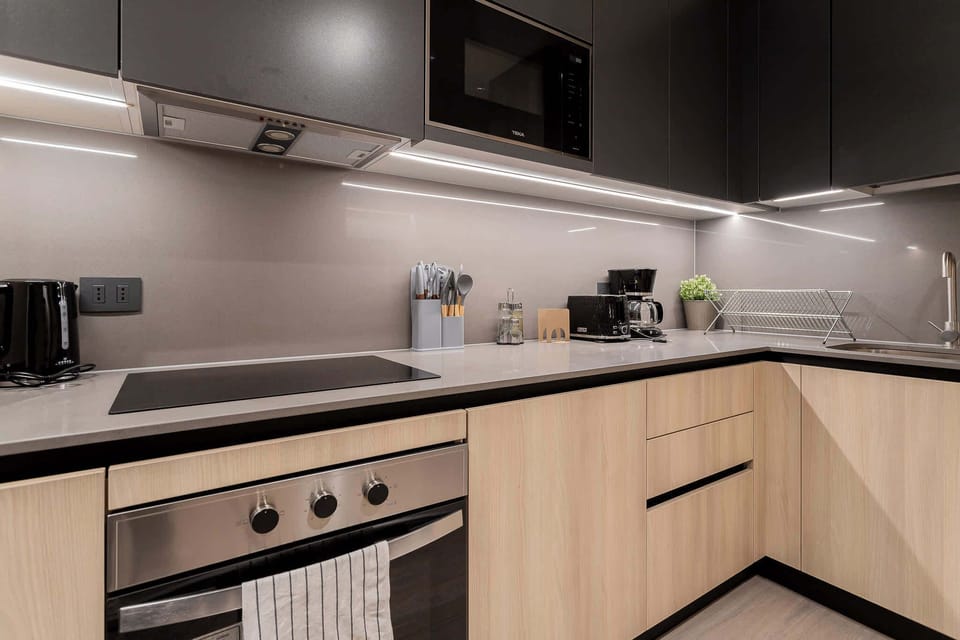 Experience culinary delight in this sleek, modern kitchen equipped with top-notch appliances and stylish finishes.