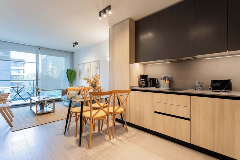 Experience modern living in this stylish kitchen and dining area, filled with natural light and contemporary decor for a cozy getaway.