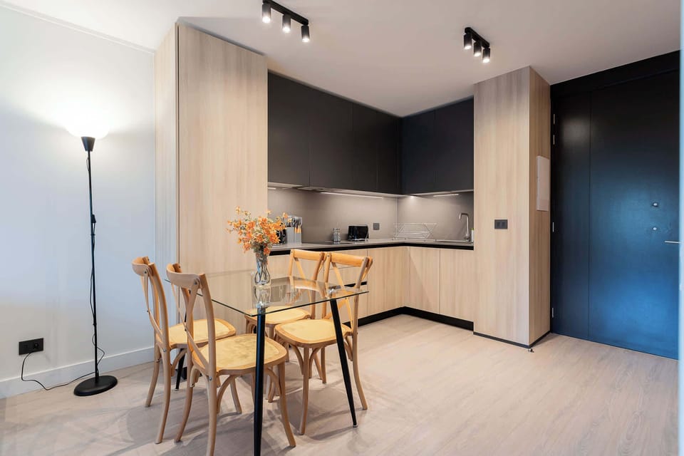 Experience modern living in this stylish kitchen, featuring a sleek design and cozy dining area perfect for meals and gatherings.