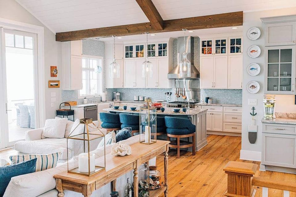 Coastal comfort meets culinary charm—gather around the heart of the home where soft hues, natural textures, and bay breezes inspire connection and conversation.