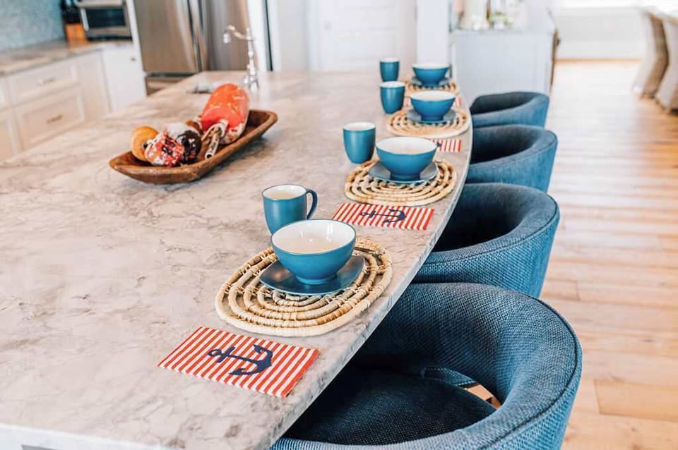 A bright beginning—gather at the textured marble island for coffee, breakfast, and making plans for the day ahead.