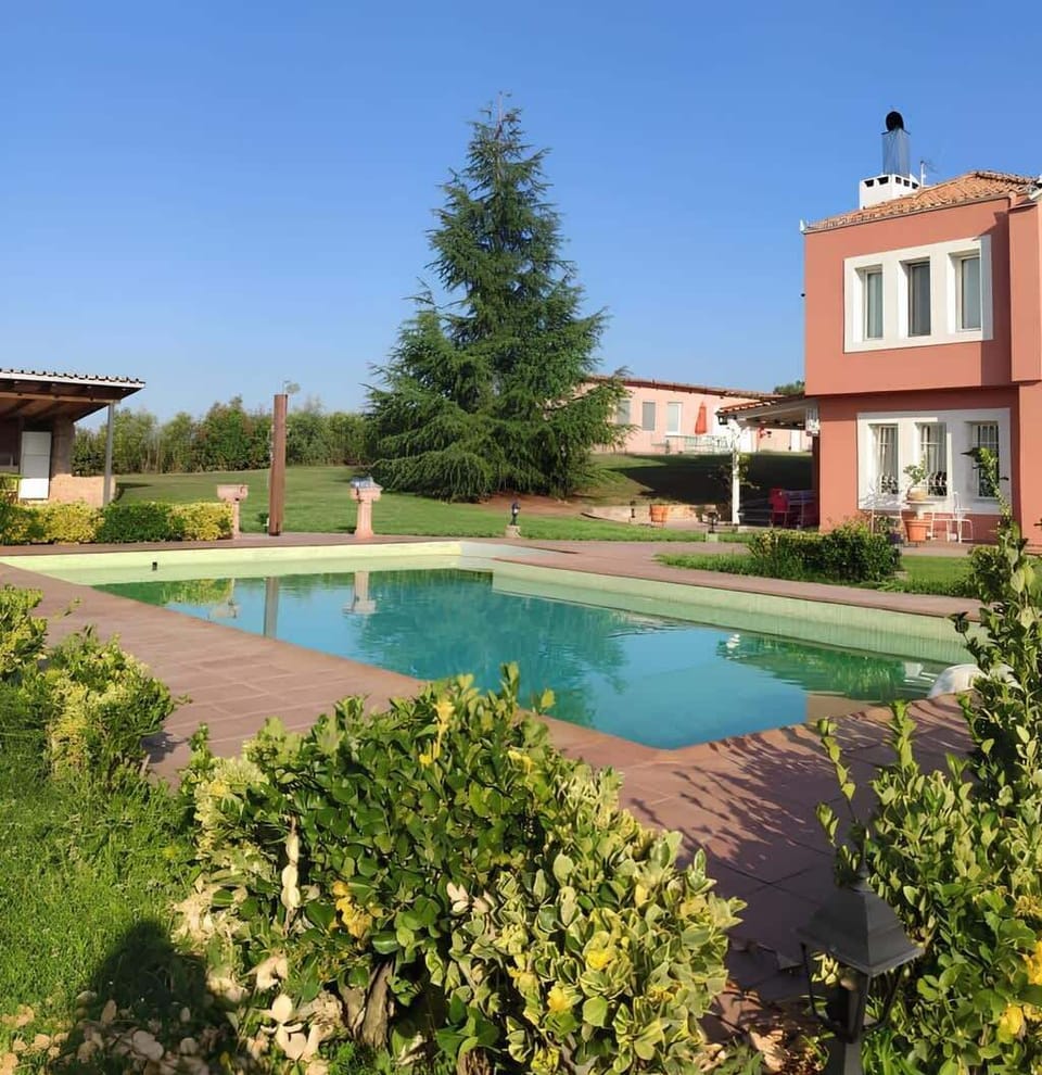 Private Swimming Pool Surrounded by Greenery and Relaxation Areas