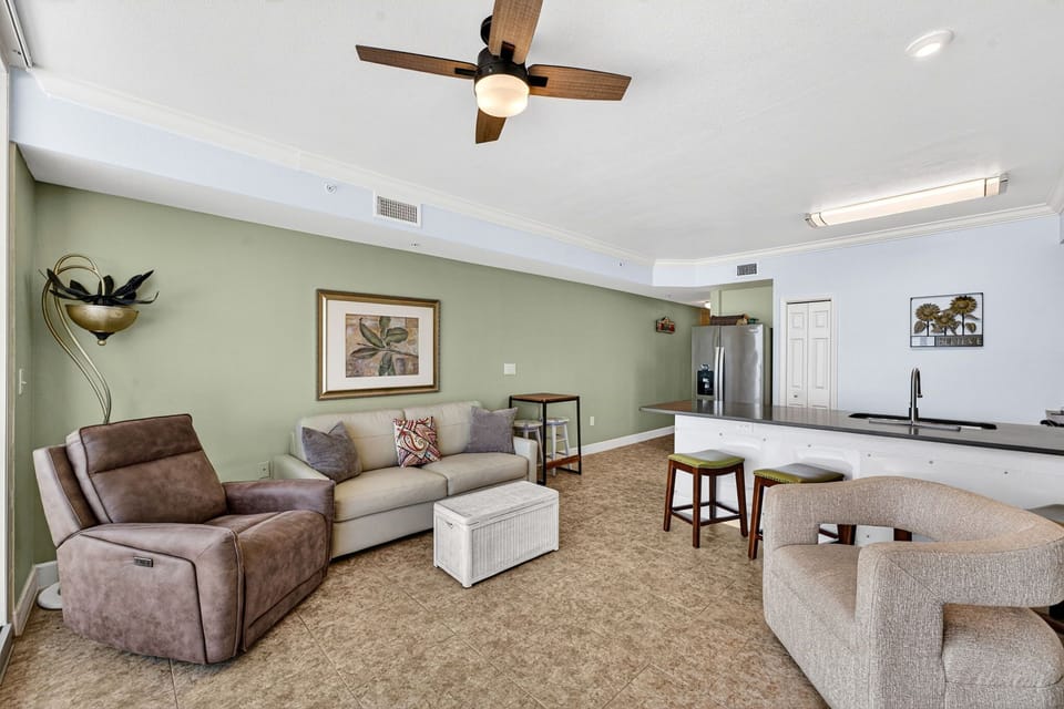 Open living area with comfortable seating and a modern kitchen bar.