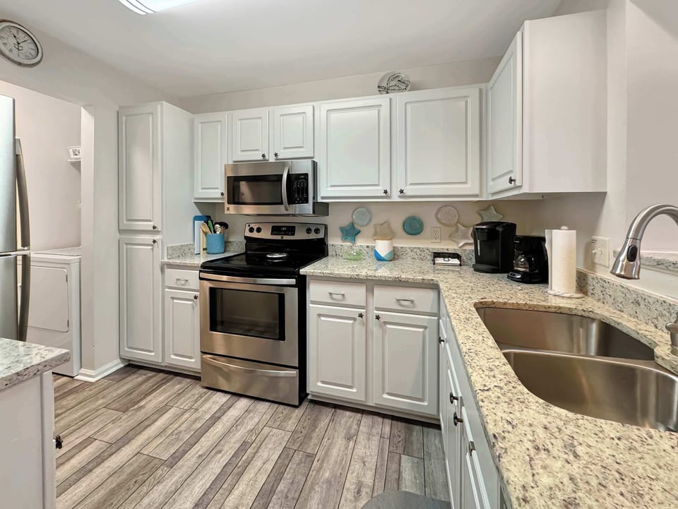 The airy kitchen offers ample space & every home comfort