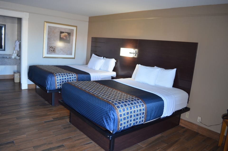 Standard Room, 2 Queen Beds | Iron/ironing board (on request), WiFi (free), bed sheets