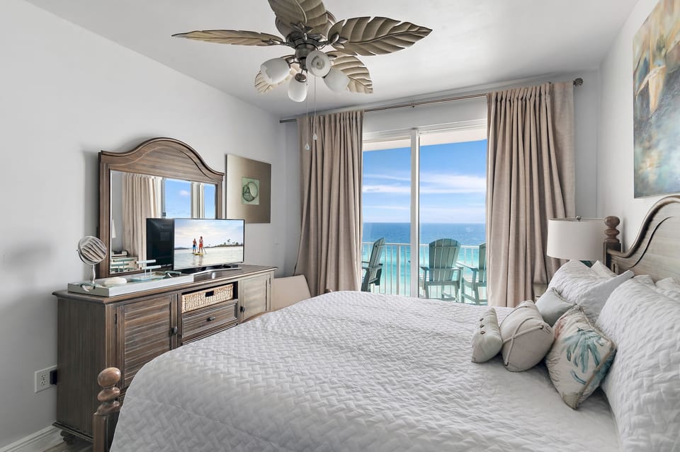 Big Gulf views from the primary bedroom which features a King Bed, new furniture, Smart TV, large closet, Chair and Desk, and private bathroom with dual vanity