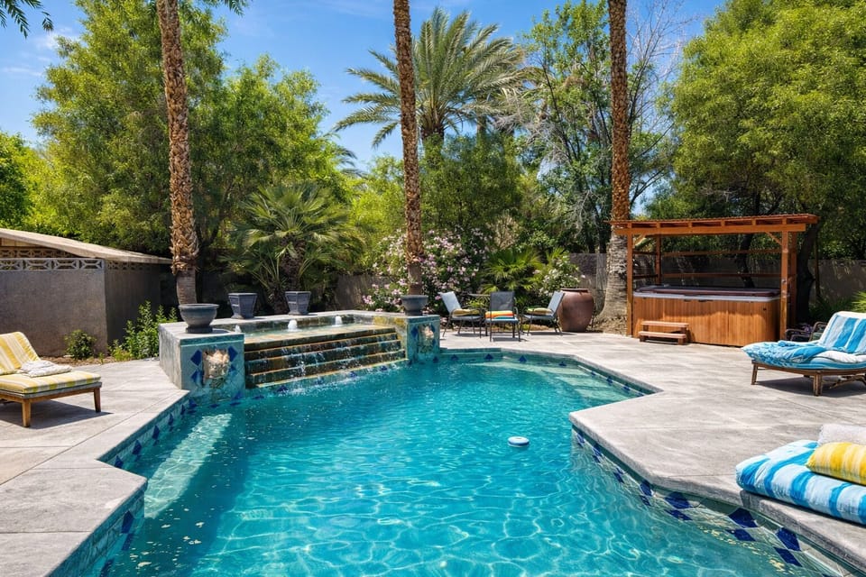 House #1 backyard with pool, spa, outdoor lounge, dining, and BBQ