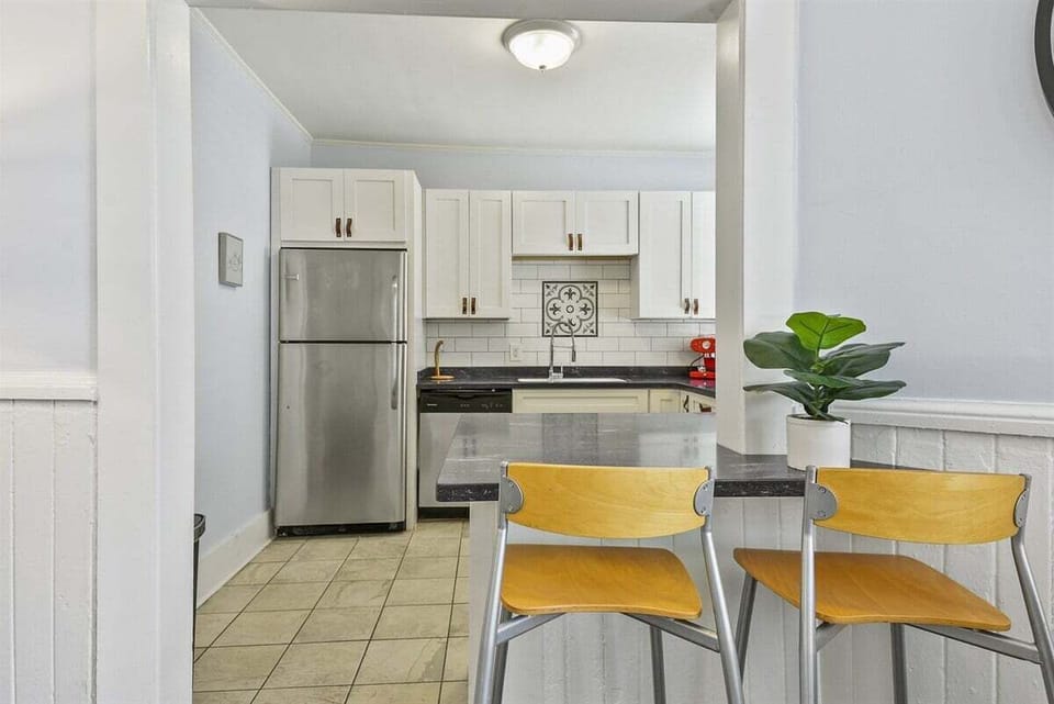 Sip and socialize at the bar, seamlessly connecting the living room and kitchen—complete with seating for two, perfect for intimate chats or quick bites!
