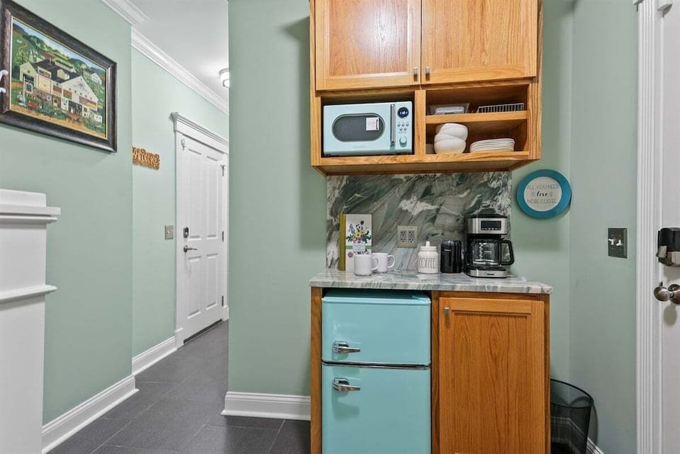 Start your day right with the convenient kitchenette—featuring a mini fridge, microwave, and a coffee bar stocked with the essentials.