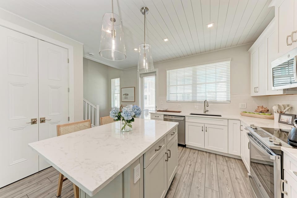 Cozy coastal kitchen has walk out balcony space