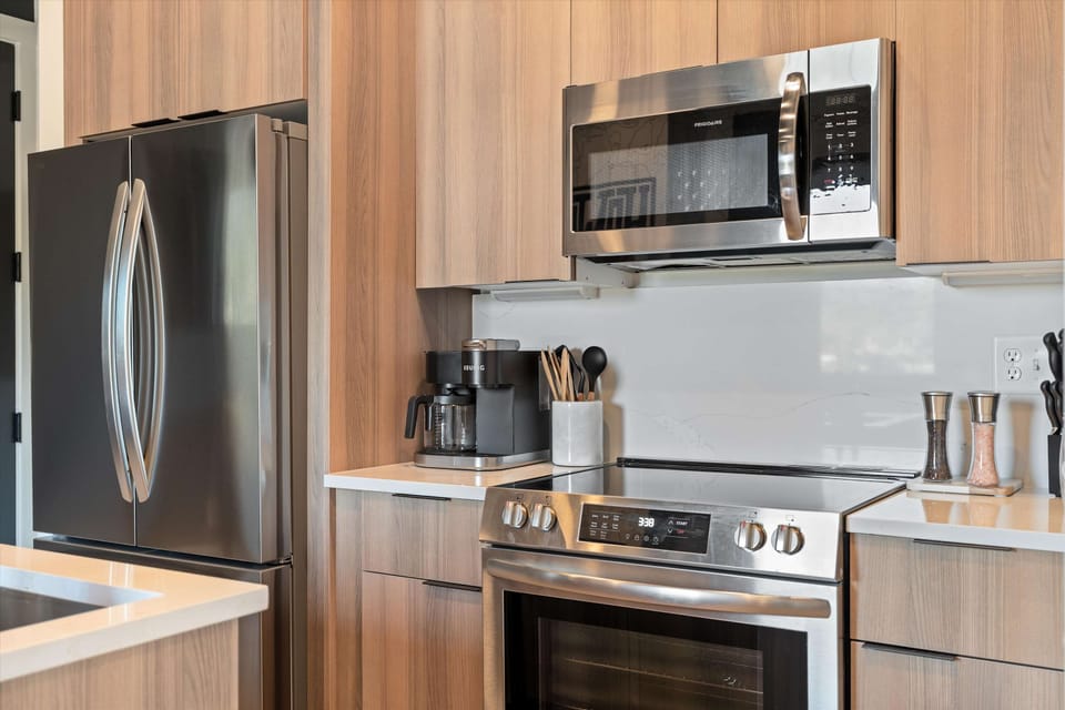 Kitchen With Stainless Steel Stove & Microwave