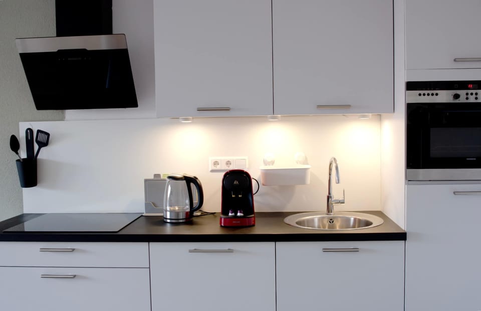 Fully equipped kitchen with cooking facilities, a coffee machine, oven and kettle