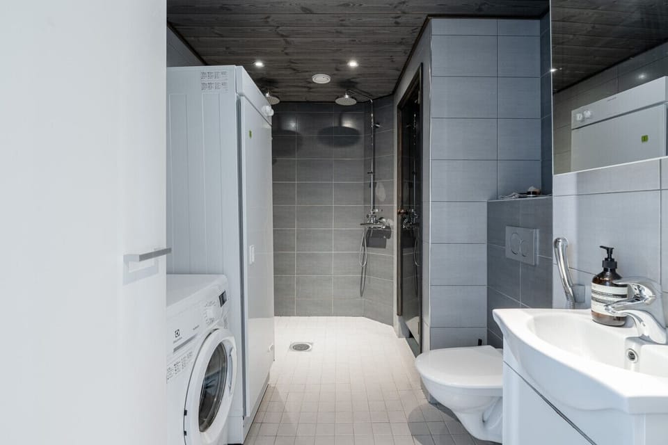 Modern bathroom complete with washing machine and drying closet — travel light!