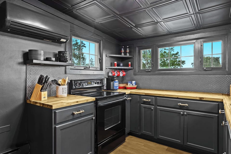 Kitchen: Red accents and modern design make this kitchen a vibrant and inviting space. Perfect for cooking up a storm!