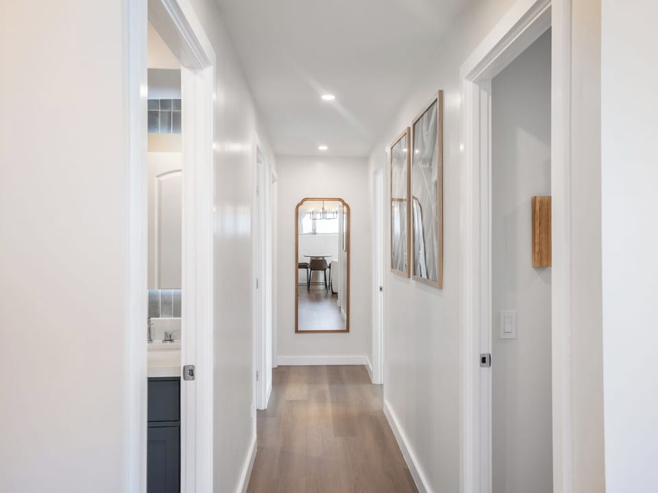 Hallway - Light corridors connect living, bedrooms, and baths. Quiet pathways that keep the condo calm and organized.
