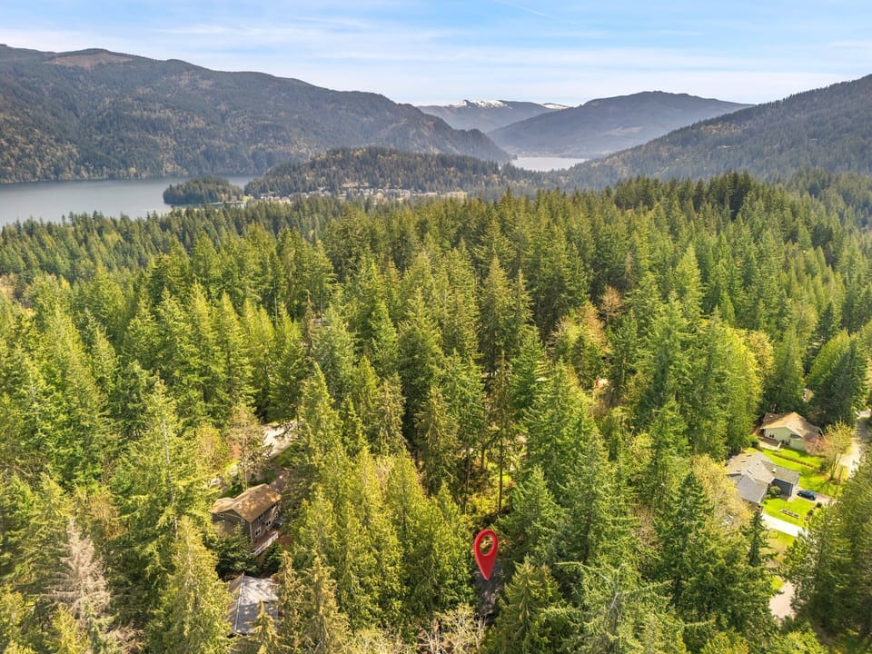 Soak in the beauty of the Pacific Northwest with sweeping aerial views of the surrounding forest and nearby lake.