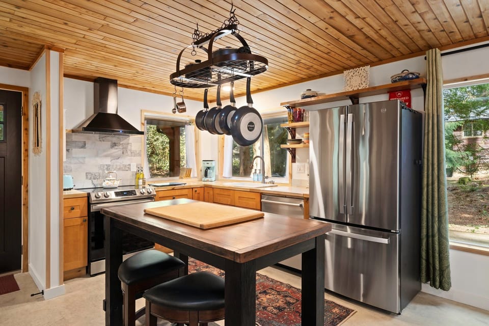 Charming copper pots and curated accents bring warmth and personality to your cooking space.