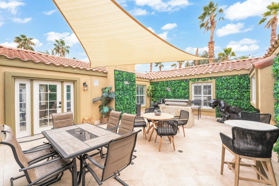 Jungle-themed center courtyard with shaded seating, outdoor dining, and BBQ